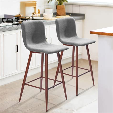 Shaped for comfort and support, this Peguero 26" Bar Stool features contemporary splayed legs and seat top accented with stunning exotic tiger bamboo. . 2 set bar stools